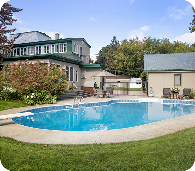 A pool that is in the middle of some grass.